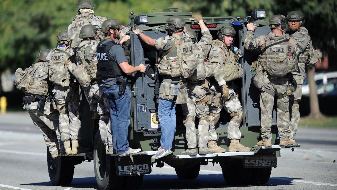 A SWAT vehicle carries police officers.