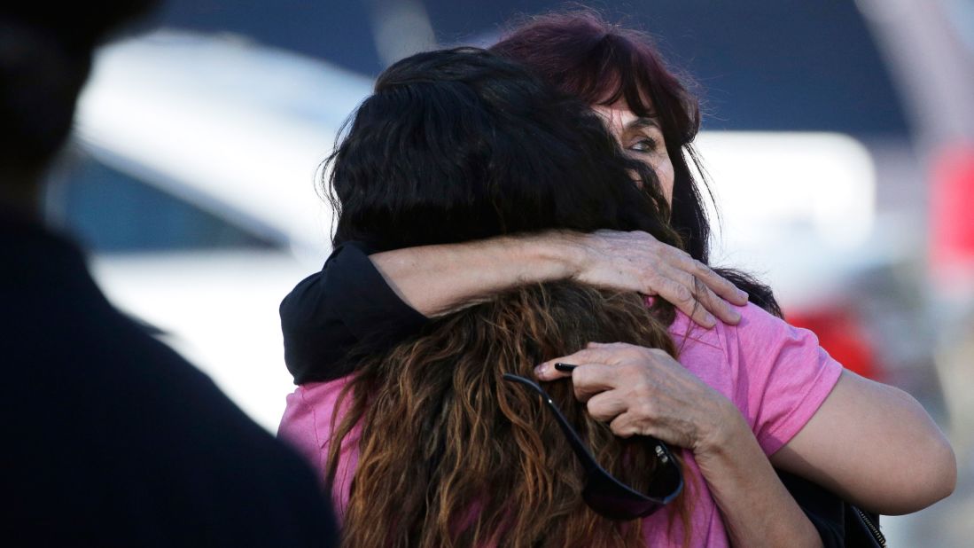 A woman is comforted near the scene of the shooting.