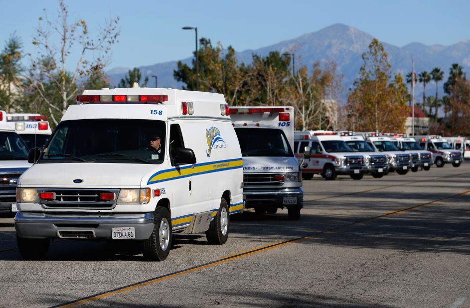 Ambulances pull out of a staging area near the Inland Regional Center.