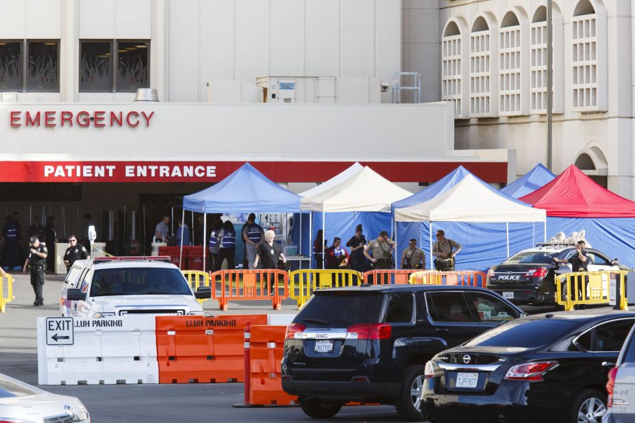 Police stand guard outside of the emergency room at the Loma Linda University Medical Center, where some of the victims were being treated.