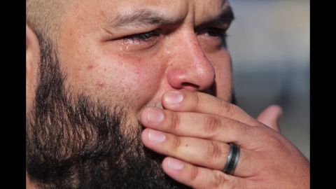 Luis Gutierrez gets emotional as he talks about his wife who works in the facility and saw a gunman, according to Los Angeles Times photographer Marcus Yam.