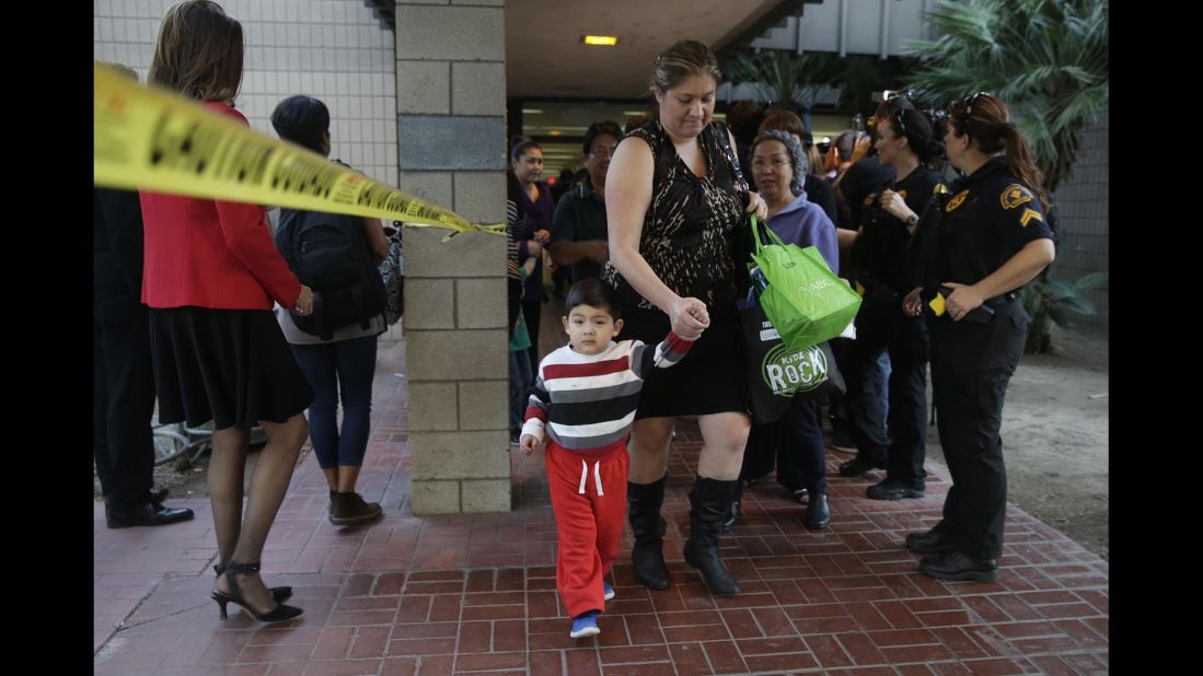 People leave a community center after reuniting with friends and family in the aftermath of the shootings.