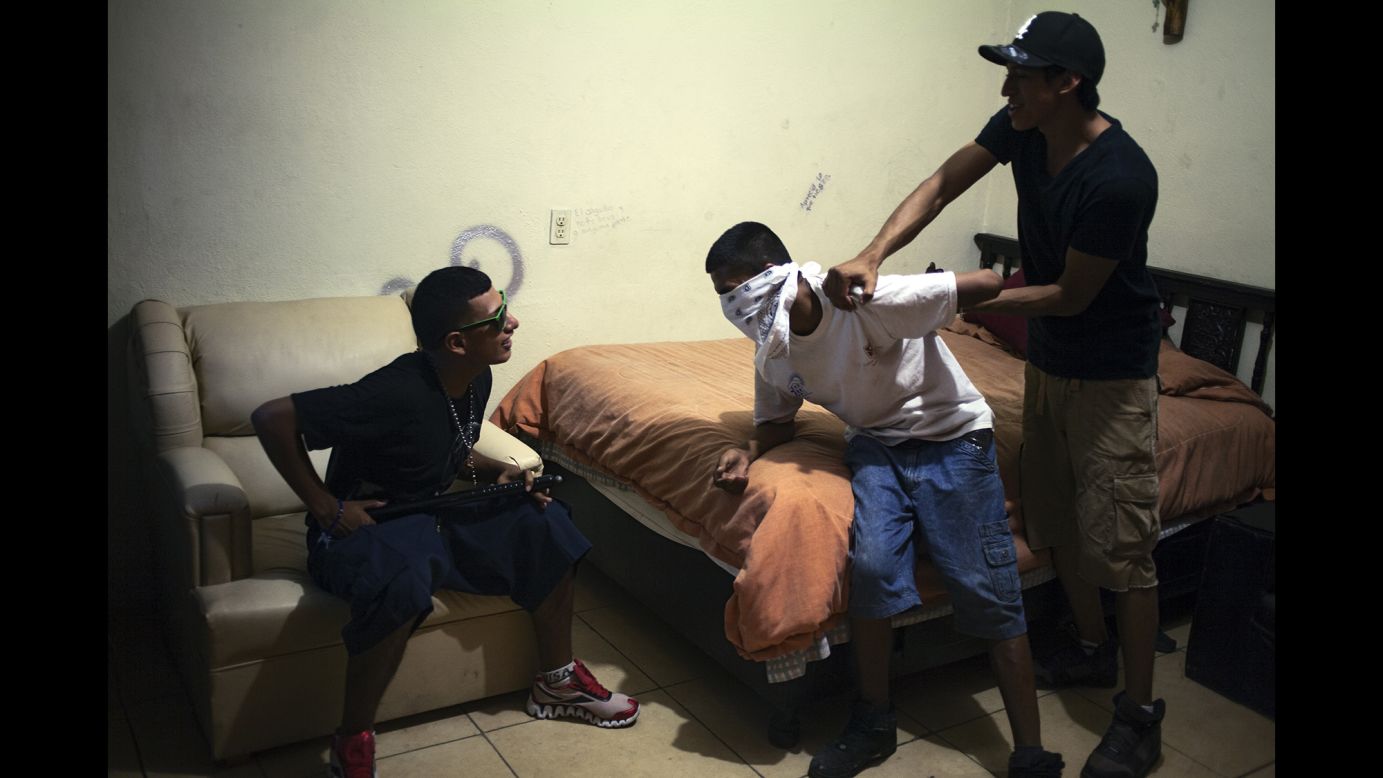 From left, Samuel, Tony and Lams mimic a kidnapping in July 2012.