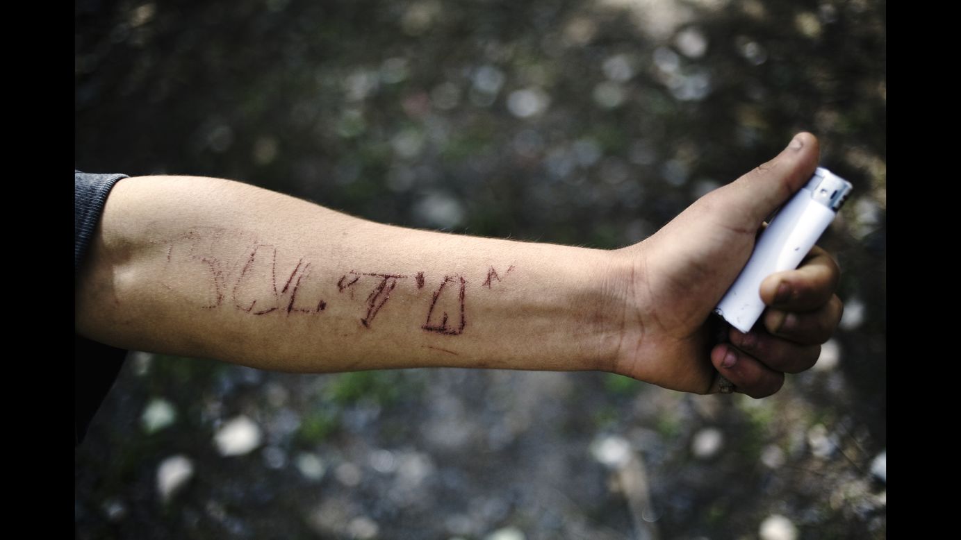 A man named Balta, who King said belonged to the street gang "Los Pokos Lokos," engraved his name into his own arm.