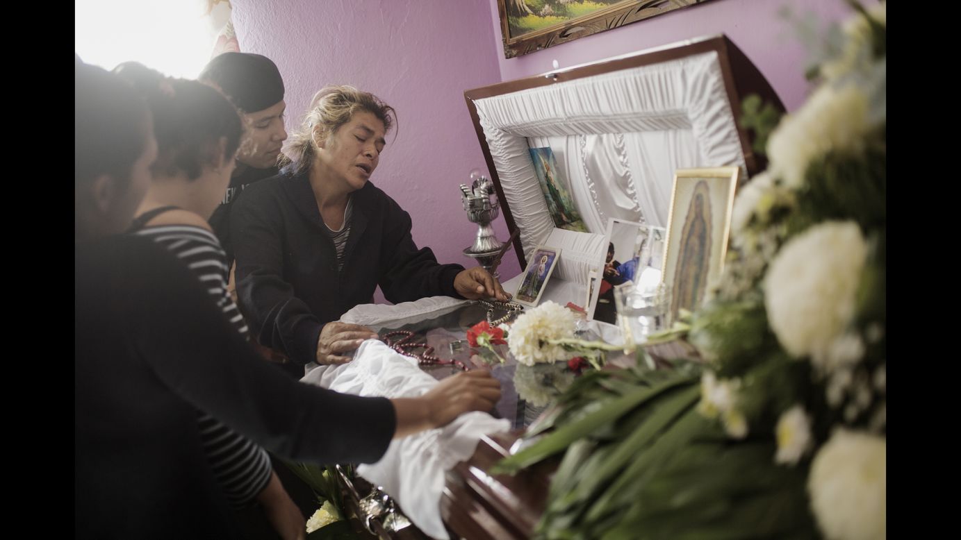 Doña Tonia mourns over the coffin of her son Manuel in January 2011. Manuel was a member of the street gang "Los Quimicos," King said, and he was kidnapped and murdered by one of the country's drug cartels.