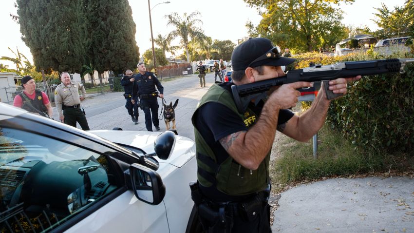 Law enforcement officers search for the suspects of a mass shooting  December 2, 2015 in San Bernardino, California.  A man and a woman suspected of carrying out a deadly shooting at a center for the disabled were killed in a shootout with police, while a third person was detained, police said.        AFP PHOTO / PATRICK T.  FALLON / AFP / Patrick T. Fallon        (Photo credit should read PATRICK T. FALLON/AFP/Getty Images)