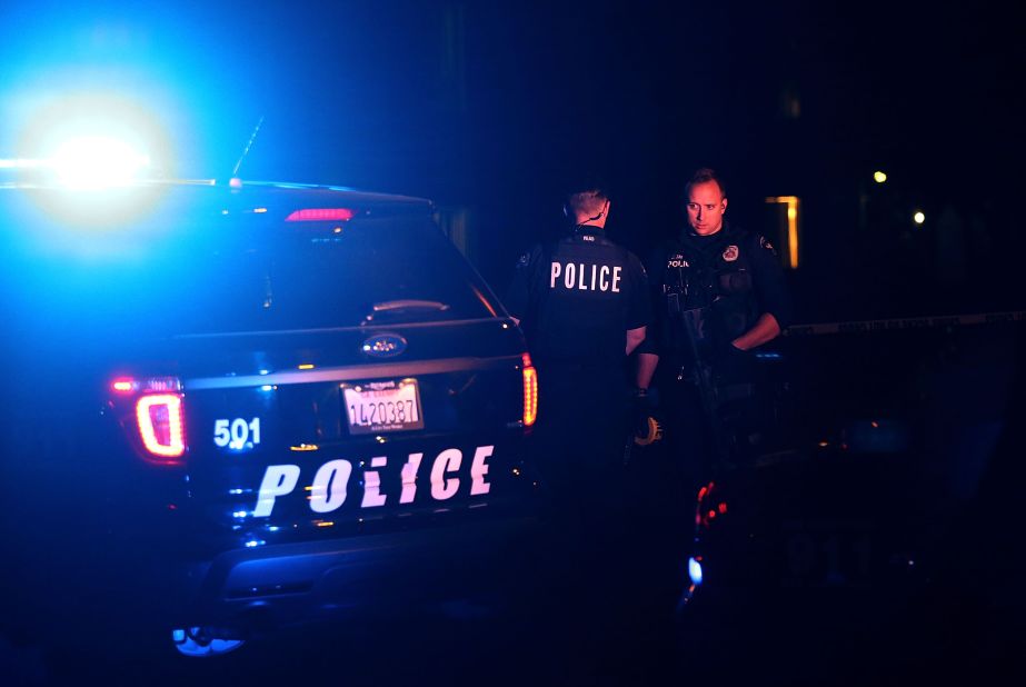 Police officers stand guard as they investigate a suspicious vehicle in Redlands, California, on Wednesday, December 2, after a mass shooting in nearby San Bernardino in which 14 people died and 21 were injured. The shooting took place at the Inland Regional Center, where employees with the county health department were attending a holiday event. The two shooters -- Syed Rizwan Farook and his wife, Tashfeen Malik -- were fatally shot in a gun battle with police hours after the initial incident. Farook worked for the county health department.