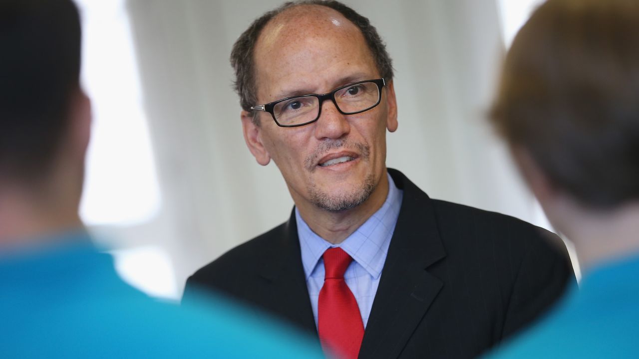 U.S. Labor Secretary Thomas Perez chats with trainees at the Siemens training facility on October 28, 2014, in Berlin.