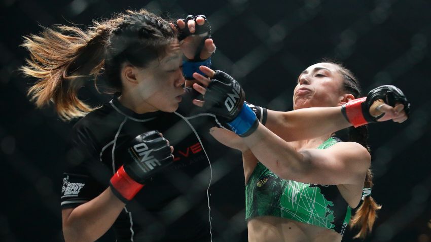 SINGAPORE - NOVEMBER 13:  Angela Lee of Singapore (L) fights Natalie Gonzales Hills of Philippines  in the Women's Strawweight bout during the One Nation Pride of Lions at Singapore Indoor Sports Stadium on November 13, 2015 in Singapore.  (Photo by Suhaimi Abdullah/Getty Images)