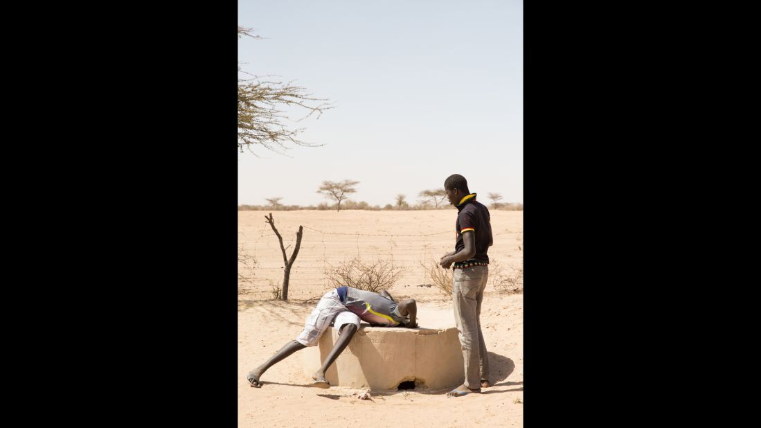 People living both on the coastline and inland have a strong relationship with and awareness of their environment. In this photo, two men look into a well, which was discovered to be too salty for farm use.