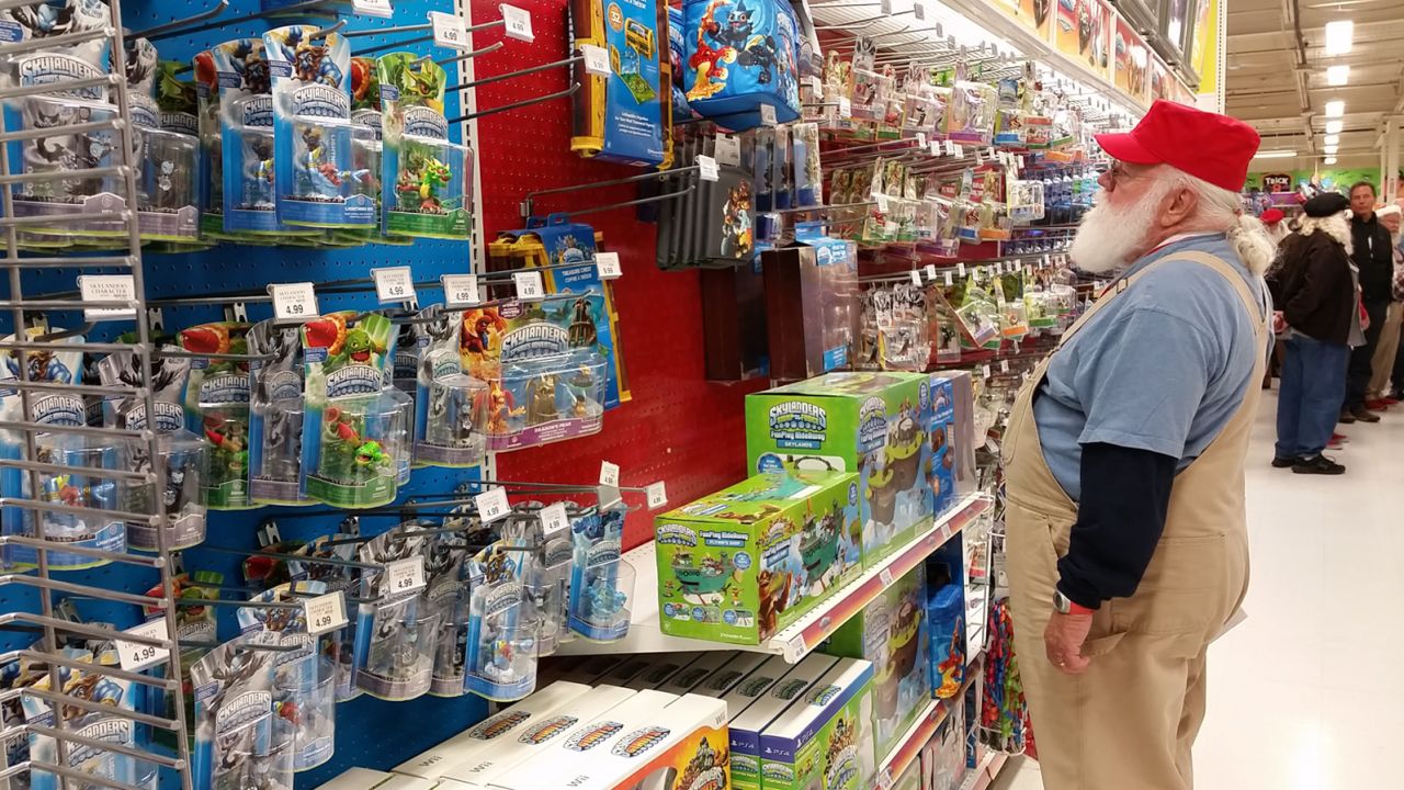 A Santa-in-training wanders the aisles at Toys R Us in Saginaw, Michigan.