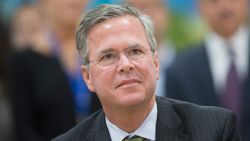 Republican presidential candidate Jeb Bush listens as Wisconsin Governor Scott Walker speaks at La Casa de Esperanza during a campaign stop the governor made with Bush on November 9, 2015 in Waukesha, Wisconsin.