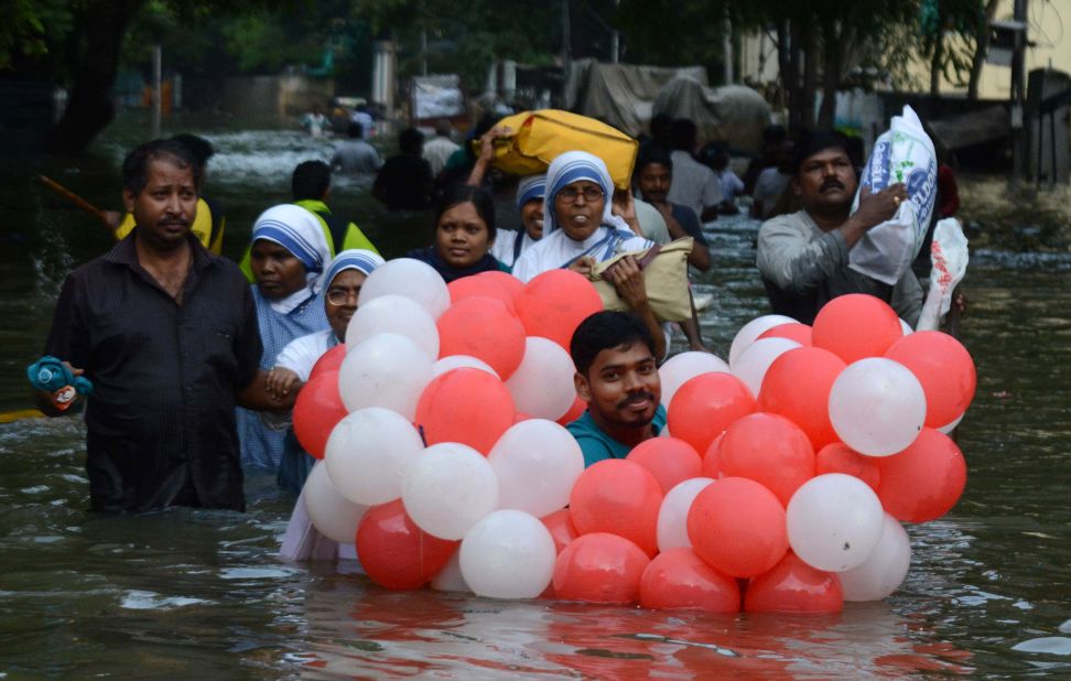 Residents walk through flood waters in Chennai, December 3.