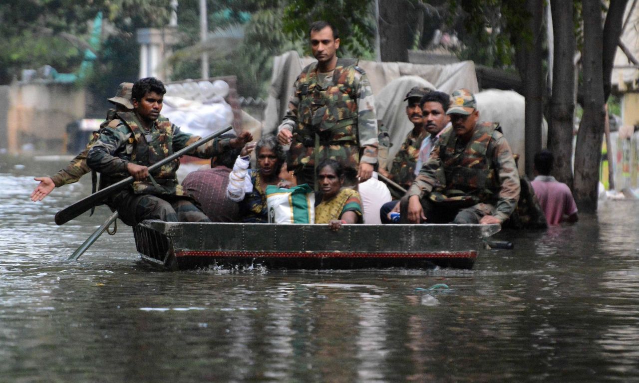 Indian army personnel use a boat to rescue residents from flood waters in Chennai on December 3.