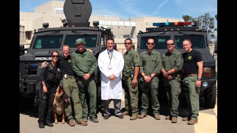 Dr. Michael Neeki, center, with officers in the probation department of San Bernadino County.
