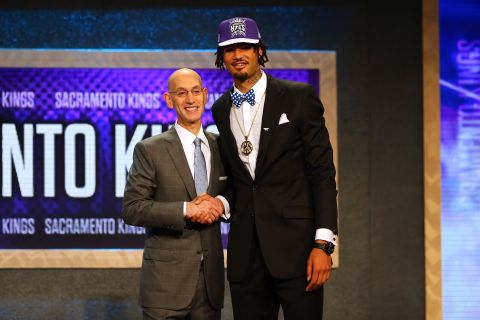 Seven-footer Willie Cauley-Stein goes with a bow tie and peace-sign pendant as he poses with Silver after being selected sixth overall by the Sacramento Kings.