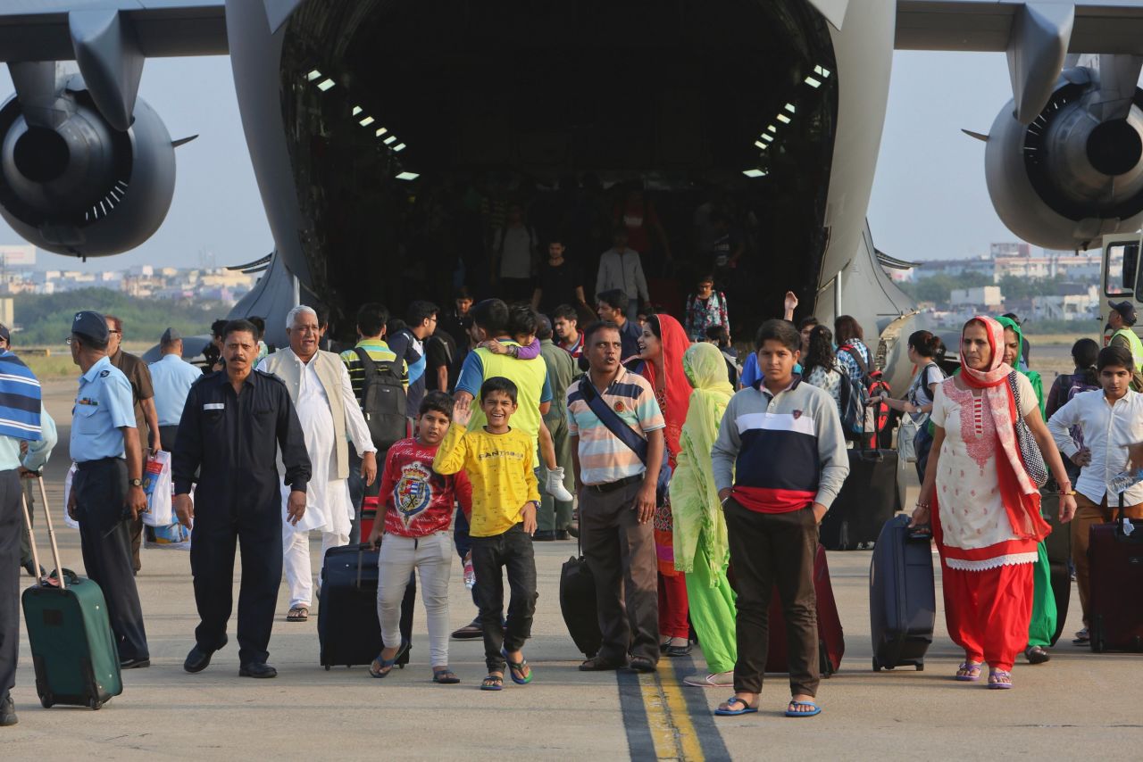 Passengers who were stranded in Chennai due to the floods and rescued in an Indian Air Force C-17 aircraft walk after it landed at the Begumpet Air Force Station, Hyderabad, December 3. 