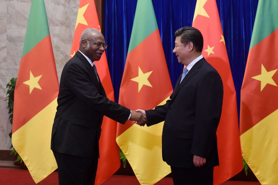 Cameroon Prime Minister Philemon Yang (L) shakes hands with Chinese President Xi Jinping (R) before their meeting at the Great Hall of the People in Beijing on June 19, 2015.  China  invested $3billion to Cameroon in 2011 towards the Memve'ele Dam project in the south of the country. 
