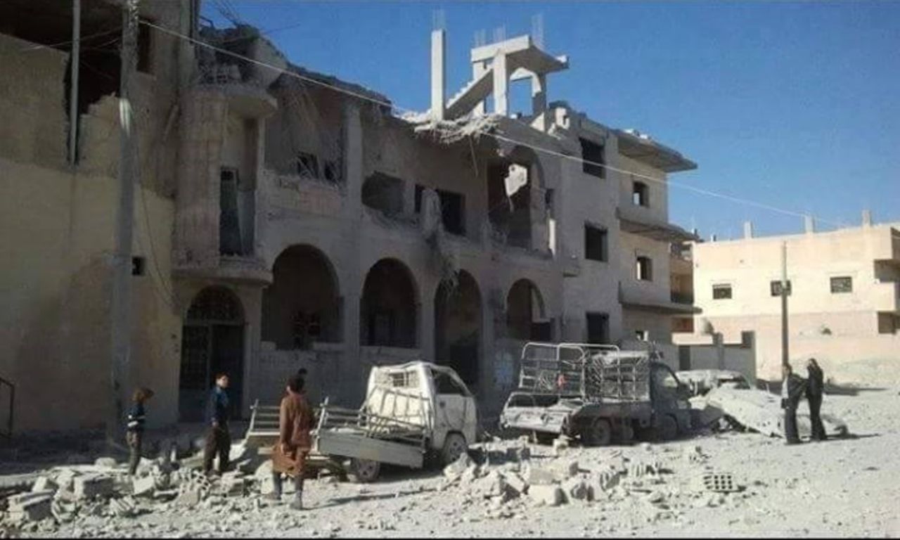 In this photo from November 29, 2015, provided to CNN by the activist group Raqqa is Being Slaughtered Silently, residents assess the damage to a building in the northern Syrian city -- ISIS's headquarters -- which has been the target of French airstrikes in recent weeks.