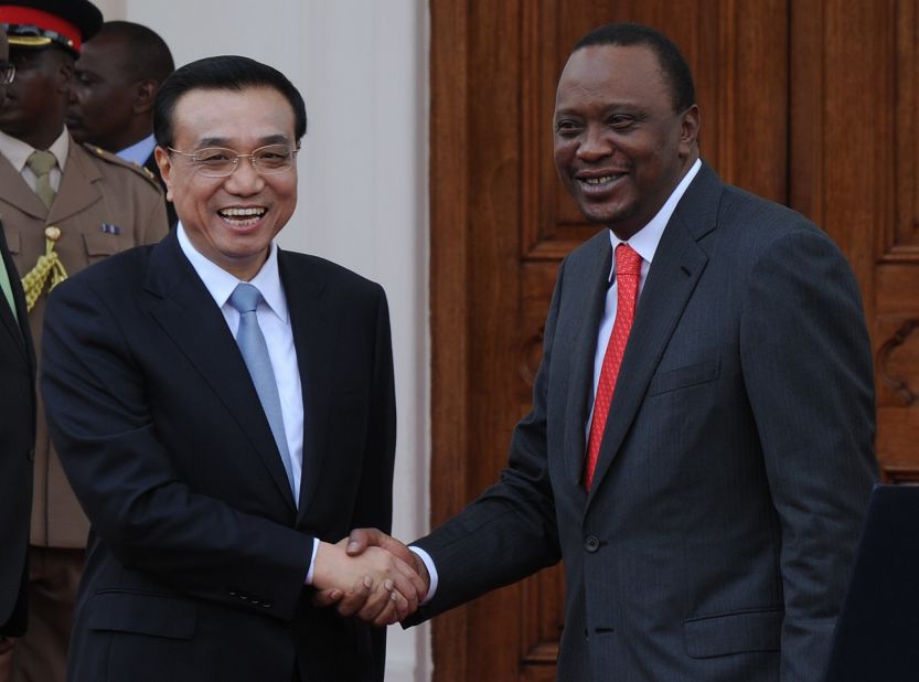 China's Premier, Li Keqiang (L) shakes hands with Kenyan President, Uhuru Kenyatta on May 10, 2014 at State House in the capital, Nairobi. Premier Li Keqiang arrived in Nairobi the day before on the final leg of a four-nation Africa tour, in a visit expected to boost trade, transport links and conservation and his first since taking office, with the world's second-biggest economy keen to boost its presence on the continent to find new markets and opportunities. 