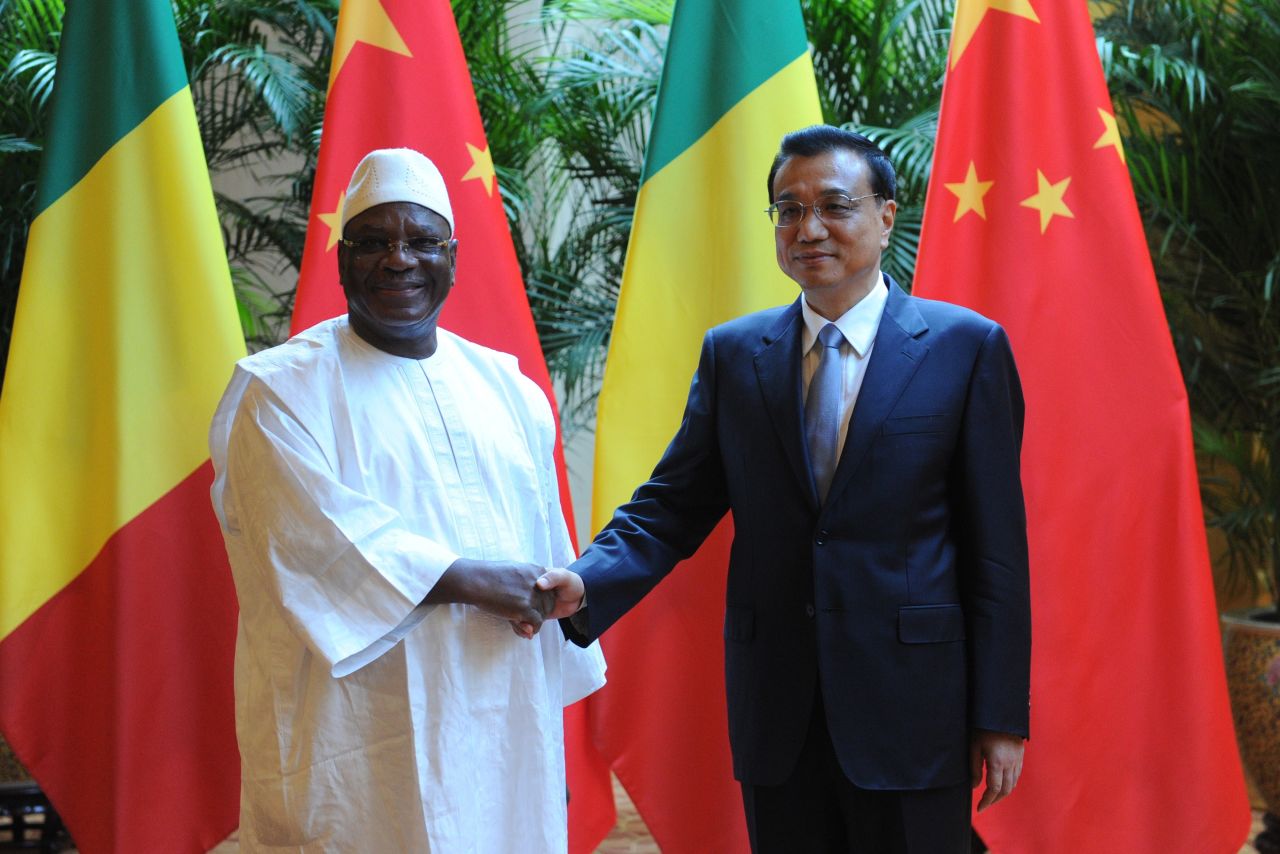 Malian President Ibrahim Boubacar Keita (L) shakes hands with Chinese Premiere Li Keqiang (R) during the World Economic Forum in Tianjin in 2014.  More recently, China has pledged to assist security operations in Mali, following an Islamist attack on a hotel in the capital Bamako in Novermber 2015.  Three Chinese nationals, who worked for the state run China Railway Construction Corp, were killed.  