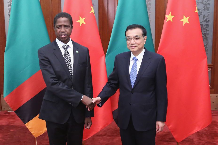 Chinese Premier Li Keqiang (R) shakes hands with Zambia's President Edgar Chagwa Lungu (Left) at the Great Hall of the People on March 30, 2015 in Beijing, China.  China has been a huge consumer of Zambia's copper exports, though the recent downturn has had a negative impact on Zambia's economy.  