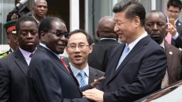 China's President Xi Jinping (2nd R) shakes  hands  with Zimbabwe's President Robert Mugabe (2nd L) as he arrive on December 1, 2015 in Harare. 
China's President Xi Jinping visited Zimbabwe on December 1 on a rare trip by a world leader to a country shunned by Western powers over President Robert Mugabe's widely-criticised record on human rights.. The two leaders held talks and oversaw the signing by their ministers of 10 agreements and memorandums of understanding covering energy, aviation, telecommunications and investment promotion deals to shore up Zimbabwe's economy, which has fallen into dire straits under Mugabe's rule.
