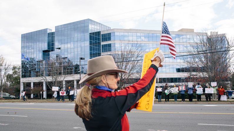 The demonstrators come in peace. They don't advertise, for fear someone will drive by and open fire. They hold signs, stand on the sidewalk and encourage passersby to honk their horns in support. 