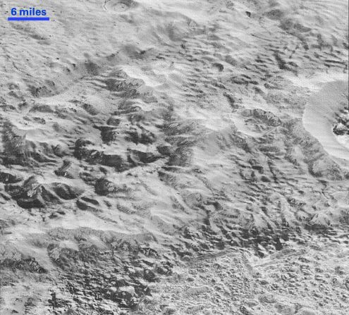 This image shows how erosion and faulting has sculpted Pluto's icy crust into rugged badlands. The prominent 1.2-mile-high cliff at the top is part of a great canyon system that stretches for hundreds of miles across Pluto's northern hemisphere, NASA says. <a href="index.php?page=&url=http%3A%2F%2Fwww.nasa.gov%2Fimage-feature%2Fpluto-s-badlands" target="_blank" target="_blank">Learn more at NASA.gov.</a>