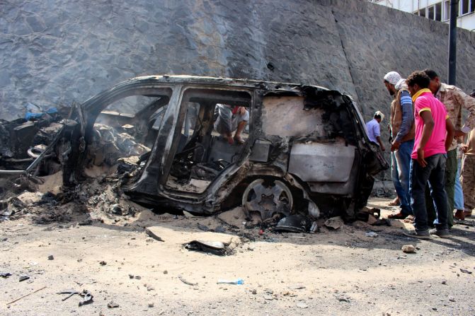 Yemenis check the scene of a car bomb attack Sunday, December 6, in Aden, Yemen. <a href="index.php?page=&url=http%3A%2F%2Fwww.cnn.com%2F2015%2F12%2F06%2Fmiddleeast%2Fyemen-aden-governor-killed%2Findex.html">Aden Gov. Jaafar Saad and six bodyguards died in the attack</a>, for which the terror group ISIS claimed responsibility.
