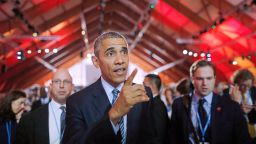 U.S. President Barack Obama walks in the main conference hall of the COP21 climate change conference in France.