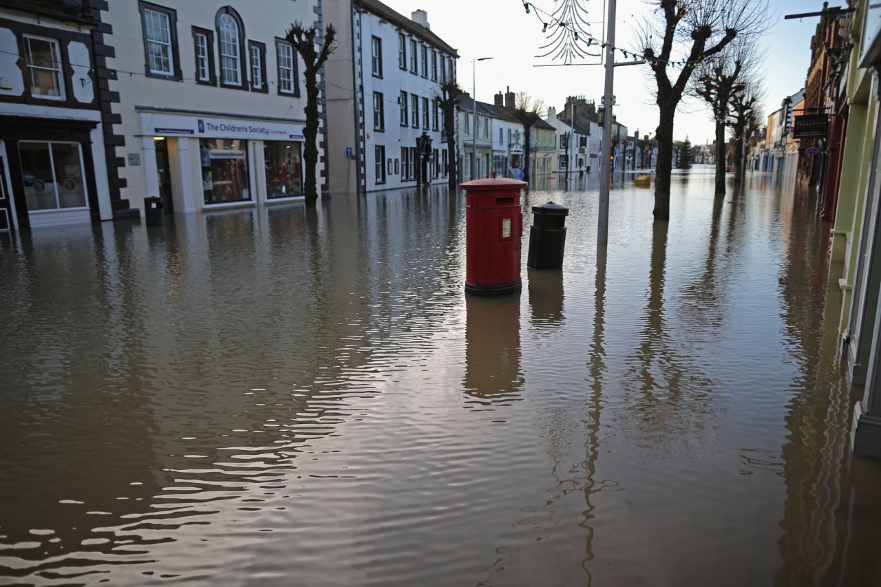 Water rises near a post box in Cockermouth, December 6.