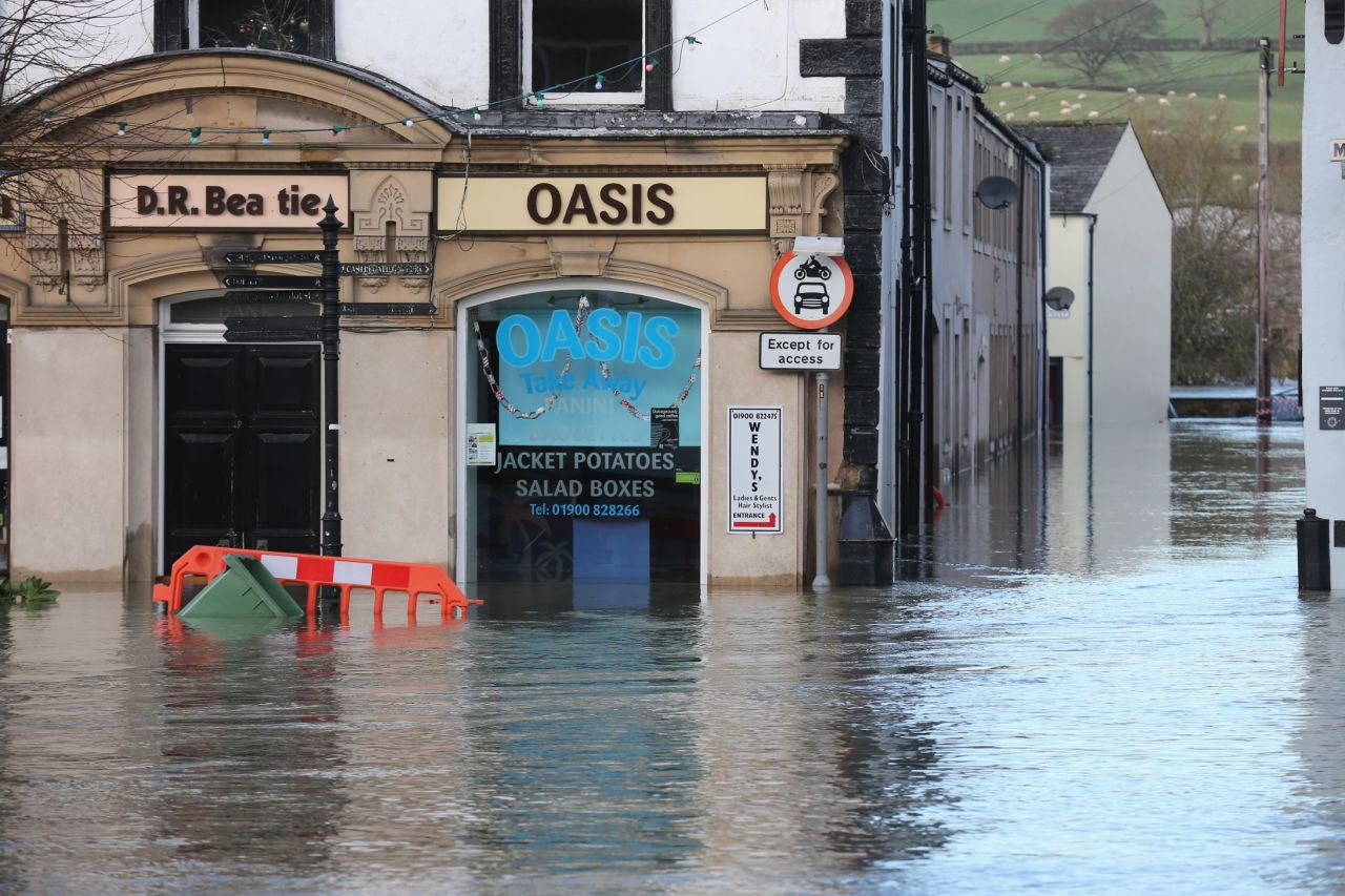 Water rises near a fast food store December 6 in Cockermouth, which sits at the confluence of the River Cocker and River Derwent. 