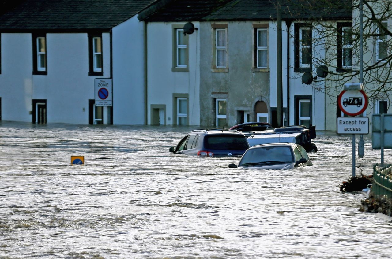 Flood water engulfs cars in the town of Cockermouth, northern England.  