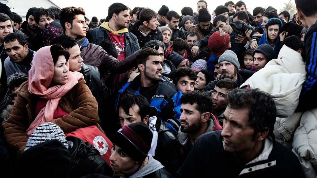 Migrants waiting to enter Macedonia stand at the border between Greece and Macedonia near the town of Idomeni, Greece, on Saturday, December 5.
