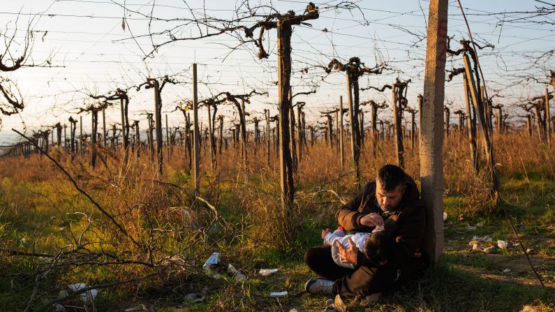 A migrant father holds his daughter after crossing the Greek-Macedonian border near the town of Gevegelija, Macedonia, on December 4.