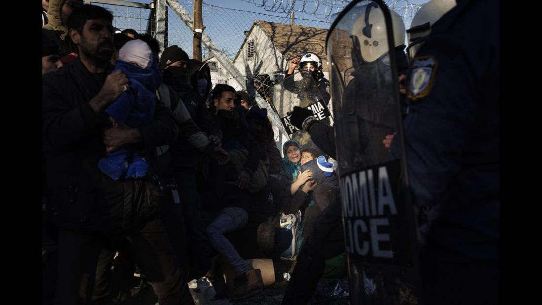 Greek anti-riot police clash with migrants near the border with Macedonia on December 4.