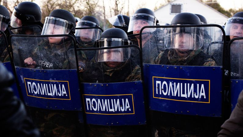 Anti-riot police block the entrance to Macedonia on Wednesday, December 3.