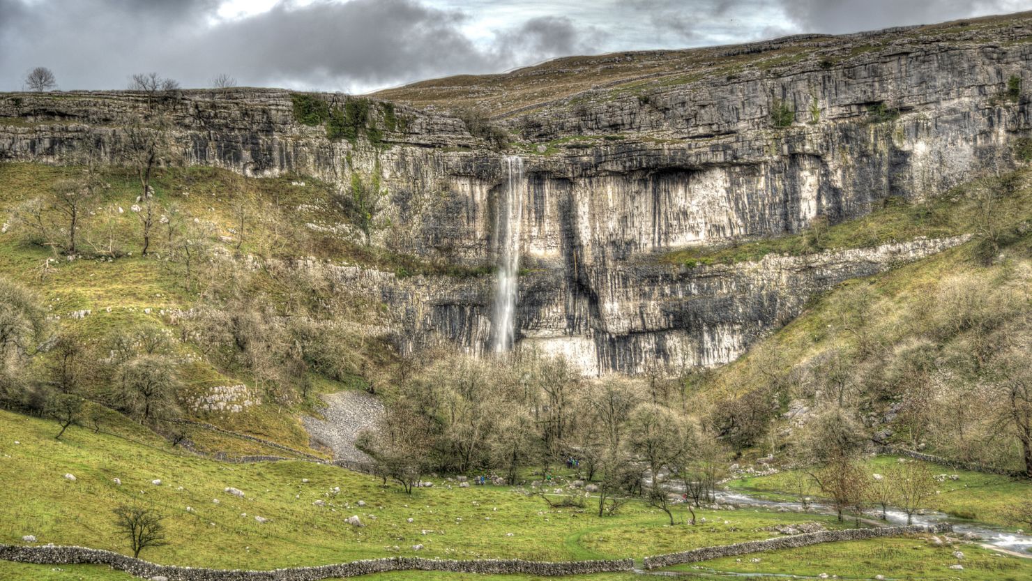 A waterfall -- which ran dry several centuries ago -- reappears at Malham Cove after the recent downpours in northern England.