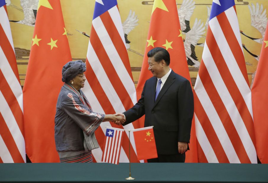 China's President Xi Jinping (R) shakes hands with Liberia's President Ellen Johnson-Sirleaf after a signing ceremony at the Great Hall of the People on November 3, 2015 in Beijing, China.  The meeting was aimied at promoting bilateral relations.  Liberia was one of the only African countries to recognize both the People's Republic of China (PRC) and the Republic of China (Taiwan), though later cut ties with Taiwan under pressure from the PRC.  