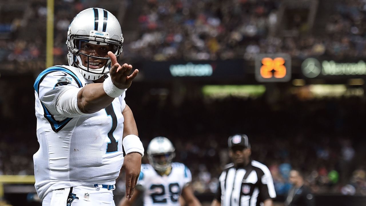 Cam Newton celebrates a touchdown during the Carolina Panthers' 41-38 victory in New Orleans on Sunday, December 6. Newton threw five touchdowns for the Panthers, who are the NFL's only undefeated team this season (12-0).