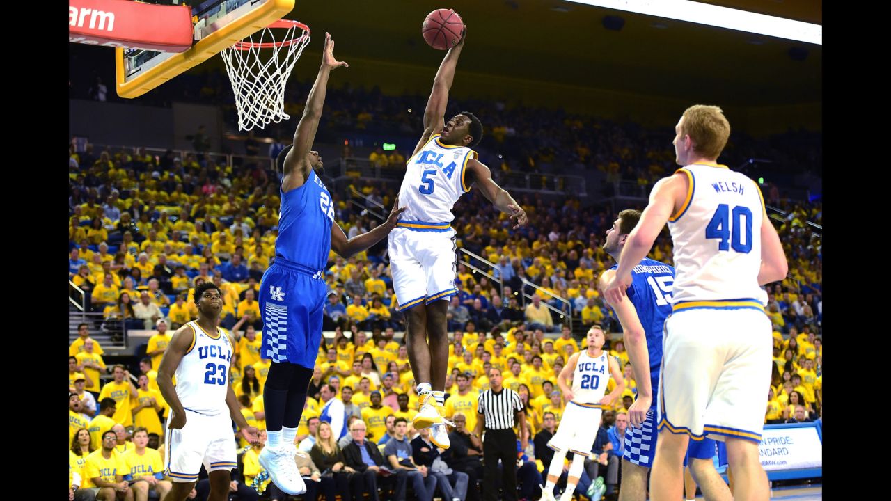 UCLA's Prince Ali dunks over Kentucky's Alex Poythress during a college basketball game in Los Angeles on Thursday, December 3. UCLA upset the top-ranked Wildcats 87-77.