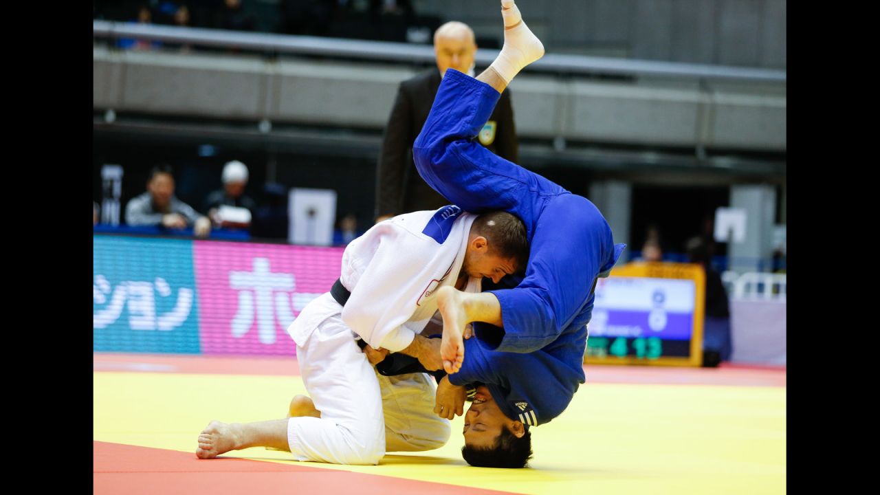 French judoka Loic Pietri, left, throws South Korea's Wang Ki-chun during the Tokyo Grand Slam on Saturday, December 5.