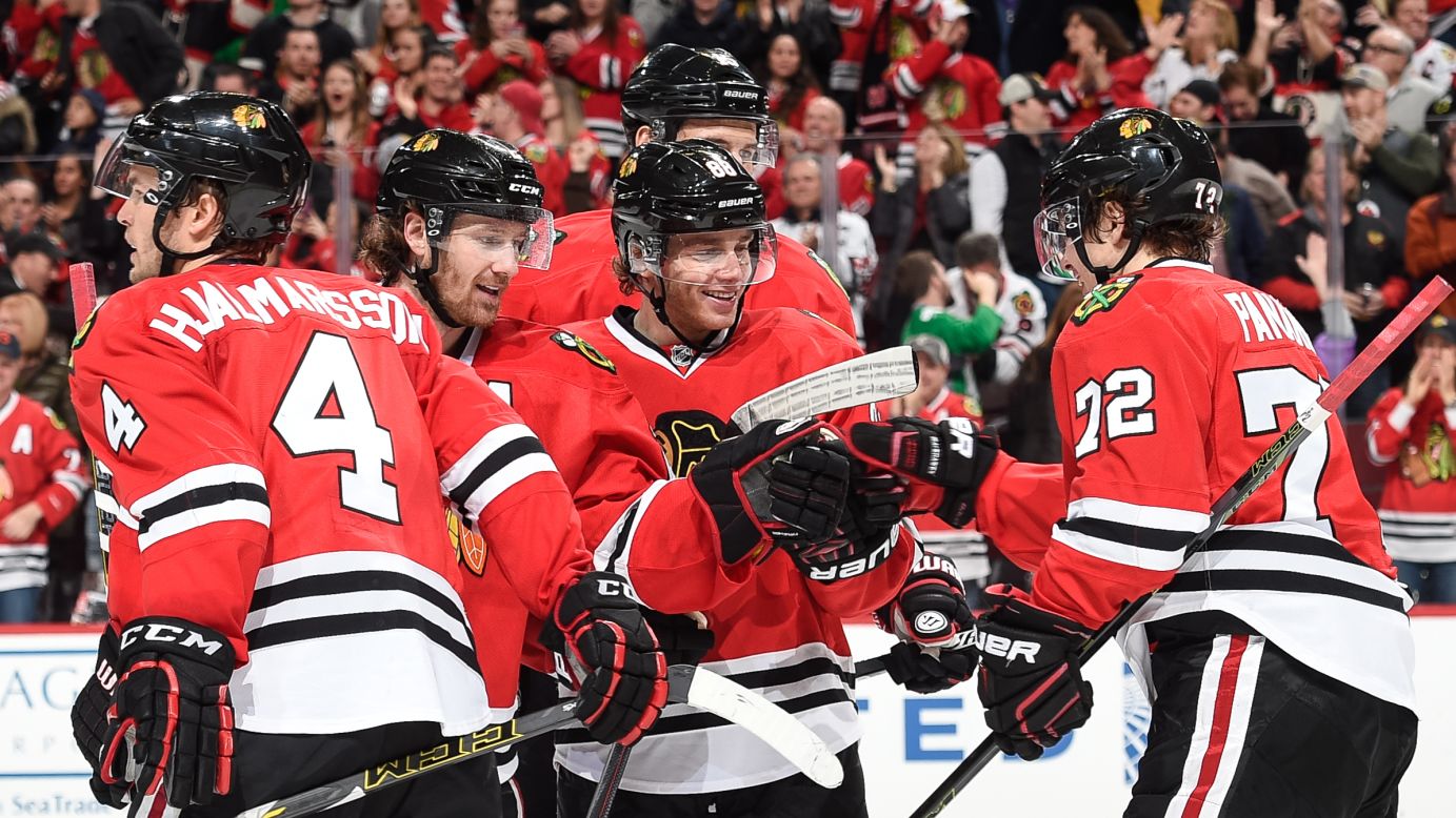 Chicago's Artemi Panarin, right, taps teammate Patrick Kane after scoring a goal against Winnipeg on Sunday, December 6. Kane's assist broke the franchise-record point streak. As of Sunday, he had gotten a goal or an assist in 22 straight games.