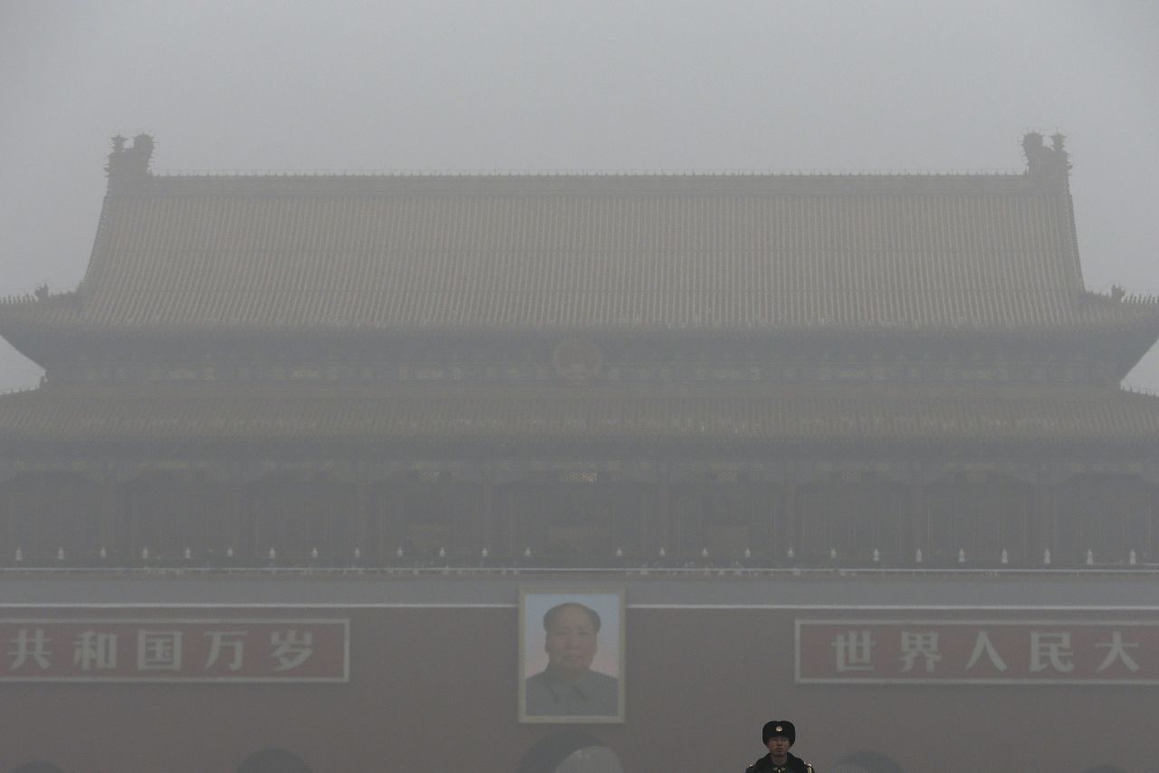 Tiananmen Gate stands shrouded with heavy pollution and fog in Beijing on December 1, 2015. Previously under an orange alert, the second-highest warning level, the Chinese capital enters yet another week choked by toxic smog under the newly issued red alert -- due to be in force until noon of December 10 local time.