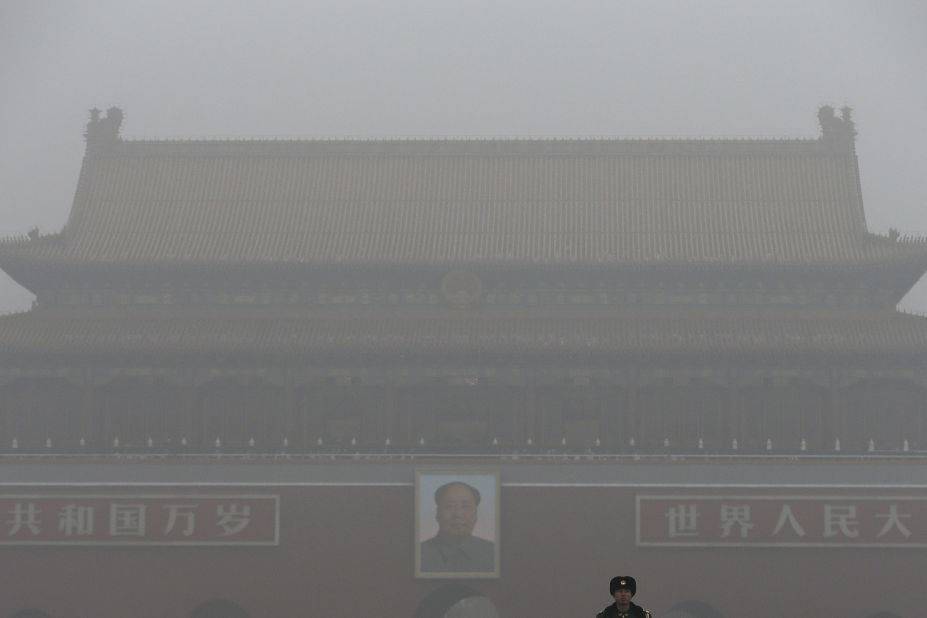 Tiananmen Gate stands shrouded with heavy pollution and fog in Beijing on December 1, 2015. Previously under an orange alert, the second-highest warning level, the Chinese capital enters yet another week choked by toxic smog under the newly issued red alert -- due to be in force until noon of December 10 local time.