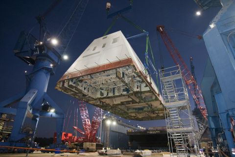 The 1,000-ton deckhouse is craned toward the deck of the ship to be integrated with the its hull at Bath Iron Works on December 14, 2012.