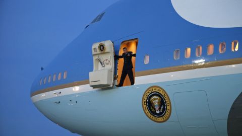 A crew member stands in the door of Air Force One as he waits for stairs to arrive Thursday, January 8, at Joint Base Andrews in Maryland. President Barack Obama was returning from a two-day trip to Michigan and Arizona.