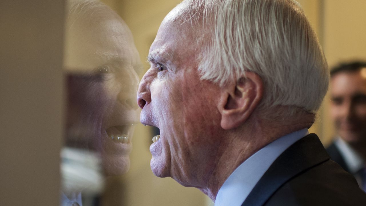 U.S. Sen. John McCain fools around with colleagues upon arriving at a news conference in Washington on Tuesday, January 13.