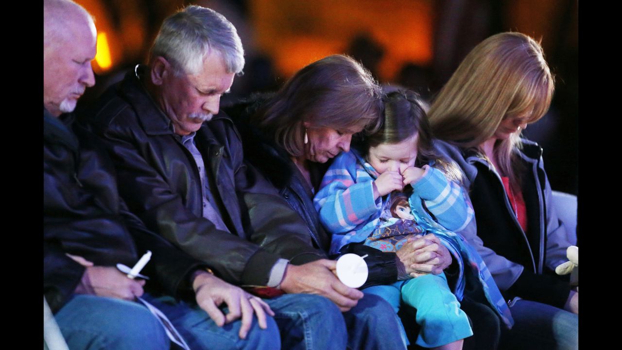 Carl Mueller, second from left, sits next to his wife, Marsha, as they honor their daughter Kayla with a candlelight vigil in Prescott, Arizona, on Wednesday, February 18. Kayla, a 26-year-old American aid worker, <a href="http://www.cnn.com/2015/02/10/world/isis-hostage-mueller/index.html" target="_blank">was killed by the militant group ISIS.</a> She had been captured in northern Syria in 2013.